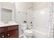 Clean bathroom featuring a single sink vanity, toilet, and a shower-tub combo with neutral decor at 7036 Kitty Hawk Ln, Fort Mill, SC 29707
