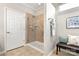 Modern bathroom featuring glass-enclosed shower, neutral tile, towel rack, and a decorative bench at 7036 Kitty Hawk Ln, Fort Mill, SC 29707