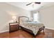 Cozy bedroom featuring hardwood floors, neutral walls, and a comfortable-looking bed with decorative pillows at 7036 Kitty Hawk Ln, Fort Mill, SC 29707