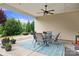 Inviting covered patio with ceiling fan, dining set, and a view of the landscaped backyard at 7036 Kitty Hawk Ln, Fort Mill, SC 29707