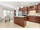 Modern kitchen with a central island, stainless steel appliances, and dark wood cabinetry at 7036 Kitty Hawk Ln, Fort Mill, SC 29707