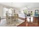 Open living and dining area filled with natural light, showcasing hardwood floors and comfortable seating at 7036 Kitty Hawk Ln, Fort Mill, SC 29707
