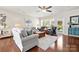Comfortable living room with hardwood floors, neutral walls, ample seating, and bright window light at 7036 Kitty Hawk Ln, Fort Mill, SC 29707