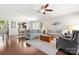 Spacious open-plan living area with hardwood floors, featuring a view of the dining room and comfortable sofas at 7036 Kitty Hawk Ln, Fort Mill, SC 29707