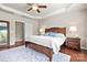 Bedroom featuring hardwood floors, tray ceiling, neutral walls, large window, and comfortable bed at 7036 Kitty Hawk Ln, Fort Mill, SC 29707