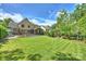 Expansive backyard features an in-ground pool, spa, wooden deck, and mature landscaping at 7428 Edenbridge Ln, Charlotte, NC 28226