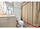 Neat bathroom featuring a toilet, shower with curtain, sink, and cabinets at 7428 Edenbridge Ln, Charlotte, NC 28226