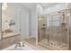 Primary bathroom features a walk-in shower with glass enclosure and tiled walls and flooring at 7428 Edenbridge Ln, Charlotte, NC 28226