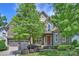 Beautiful stone-faced two-story home with a well-manicured lawn and attached two-car garage at 7428 Edenbridge Ln, Charlotte, NC 28226