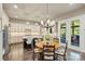 Open-concept kitchen and breakfast nook features stainless steel appliances, island and a view to porch at 7428 Edenbridge Ln, Charlotte, NC 28226