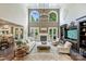 Spacious open-concept living room with cathedral ceilings, fireplace, and refined furniture at 7428 Edenbridge Ln, Charlotte, NC 28226