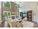 Bright, open living room with high ceilings, a fireplace, and large windows providing ample natural light at 7428 Edenbridge Ln, Charlotte, NC 28226