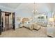 Beautiful main bedroom with light filled window, decorative molding, and doorway to en suite at 7428 Edenbridge Ln, Charlotte, NC 28226