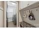 Mud room features storage cabinets, coat hooks and access to laundry area with washer and dryer at 7428 Edenbridge Ln, Charlotte, NC 28226