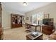 Well-lit office featuring wood desk, bookshelf, carpet, and natural light at 7428 Edenbridge Ln, Charlotte, NC 28226