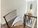 View from upper staircase landing with wrought iron railing and large window above front door at 7428 Edenbridge Ln, Charlotte, NC 28226