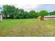 The lush backyard has mature trees, a shed and play set at 8282 Park Edwards Rd, Kannapolis, NC 28081
