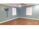 Spacious bedroom with hardwood floors, neutral walls, and ample natural light from two windows at 8282 Park Edwards Rd, Kannapolis, NC 28081