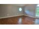 A bedroom featuring neutral walls, hardwood floors and unique octagon shaped window for lots of light at 8282 Park Edwards Rd, Kannapolis, NC 28081
