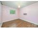Charming bedroom with hardwood floors, chandelier, and decorative wall accents at 8282 Park Edwards Rd, Kannapolis, NC 28081