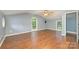 Spacious bedroom featuring hardwood floors, a ceiling fan, and two windows for plenty of light at 8282 Park Edwards Rd, Kannapolis, NC 28081
