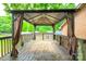View of the covered wood deck and backyard, perfect for relaxing and enjoying the outdoors at 8282 Park Edwards Rd, Kannapolis, NC 28081