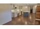 Wide view of the kitchen with its open-concept and stainless steel appliances, marble countertops, and blue subway tile at 8282 Park Edwards Rd, Kannapolis, NC 28081