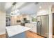 Kitchen with stainless steel appliances, marble countertops, a blue island, and ample cabinet space for storage at 8282 Park Edwards Rd, Kannapolis, NC 28081