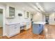 Charming kitchen with island, marble countertops, custom cabinets, and built in desk at 8282 Park Edwards Rd, Kannapolis, NC 28081