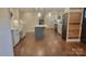 A full view of a recently renovated kitchen with stainless steel appliances, marble countertops, blue subway tile, and an island at 8282 Park Edwards Rd, Kannapolis, NC 28081