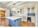 Bright kitchen features a large island with a marble countertop, stainless steel wine cooler, and modern lighting fixtures at 8282 Park Edwards Rd, Kannapolis, NC 28081