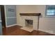 Living room featuring a brick fireplace with wooden mantle and wood flooring at 8282 Park Edwards Rd, Kannapolis, NC 28081