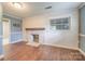 Living room featuring a cozy fireplace, white paneling, and attractive hardwood floors, great for relaxing and entertaining at 8282 Park Edwards Rd, Kannapolis, NC 28081