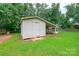 Exterior view of the backyard outbuilding with a white exterior and partial awning at 8282 Park Edwards Rd, Kannapolis, NC 28081