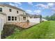 Attractive backyard with brick paver patio, large grassy area and a privacy fence on a sunny day at 829 River Park Rd, Belmont, NC 28012