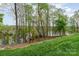 Picturesque backyard with lush greenery and serene views of the water at 829 River Park Rd, Belmont, NC 28012