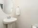 Bathroom featuring a modern pedestal sink, round mirror and towel rack at 829 River Park Rd, Belmont, NC 28012