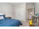 Cozy bedroom with plush carpeting, closet with doors, and ample natural light from adjacent hall at 829 River Park Rd, Belmont, NC 28012