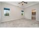 Spacious carpeted main bedroom featuring two windows and ensuite bathroom at 829 River Park Rd, Belmont, NC 28012
