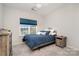 Comfortable bedroom with a window view, cozy blue comforter, and stylish side table at 829 River Park Rd, Belmont, NC 28012
