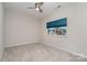Bright bedroom featuring neutral walls, plush carpeting, a ceiling fan, and a large window at 829 River Park Rd, Belmont, NC 28012