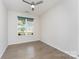Bright bedroom features hardwood floors, a ceiling fan and a large window at 829 River Park Rd, Belmont, NC 28012