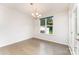 Bright dining area with hardwood floors, modern chandelier, and a large window, perfect for entertaining at 829 River Park Rd, Belmont, NC 28012