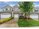 Charming townhome exterior with stone accents, a well-manicured lawn, and an attached one-car garage at 829 River Park Rd, Belmont, NC 28012