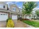 Well-maintained townhome with a stone facade, attached garage, and lush landscaping in a desirable neighborhood at 829 River Park Rd, Belmont, NC 28012