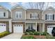 Charming townhome with stone accents, attached garage, and cozy front porch with chairs at 829 River Park Rd, Belmont, NC 28012