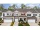 Charming townhome with stone accents, attached garage, and cozy front porch with chairs at 829 River Park Rd, Belmont, NC 28012