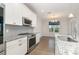 Modern kitchen boasts stainless steel appliances, granite countertops, and stylish backsplash at 829 River Park Rd, Belmont, NC 28012