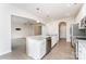 Bright kitchen featuring a large center island with seating, stainless steel appliances, and hardwood floors at 829 River Park Rd, Belmont, NC 28012