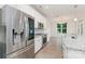 Gourmet kitchen featuring stainless steel appliances, granite countertops, and stylish white cabinetry at 829 River Park Rd, Belmont, NC 28012